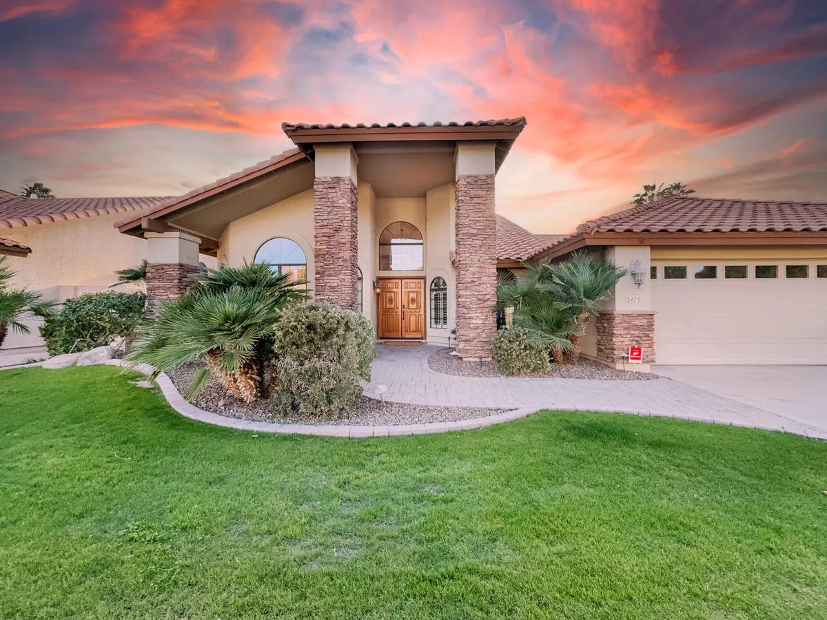 The main entrance of the home with impressive double doors, stone pillars, and a landscaped front yard. The space is inviting and well-maintained, creating a welcoming first impression for guests and family members alike. The area suggests easy flow between indoor and outdoor experiences, aligning with the section's emphasis on group activities and arrivals.
